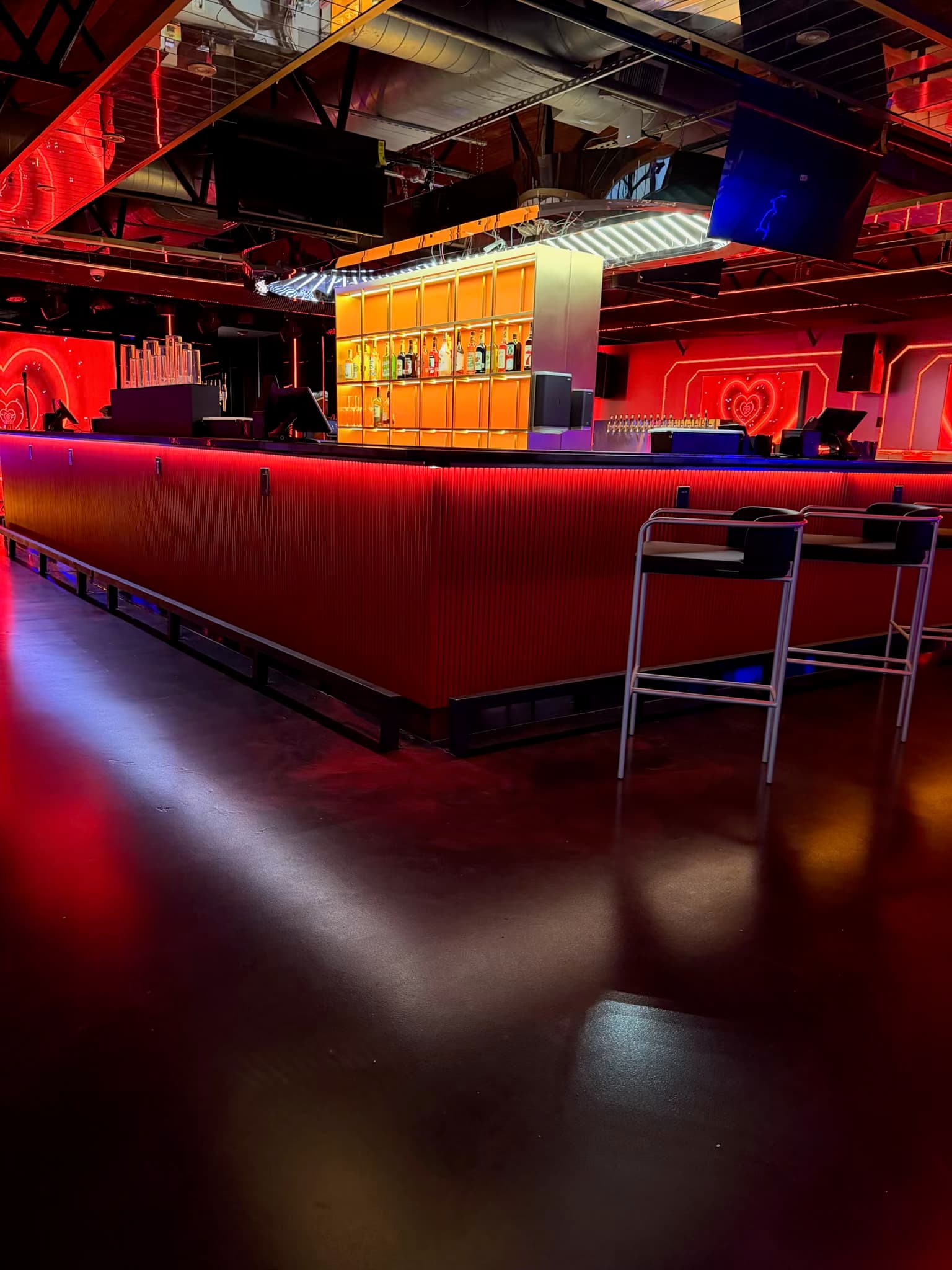 The illuminated red bar inside 69 Lounge in Houston
