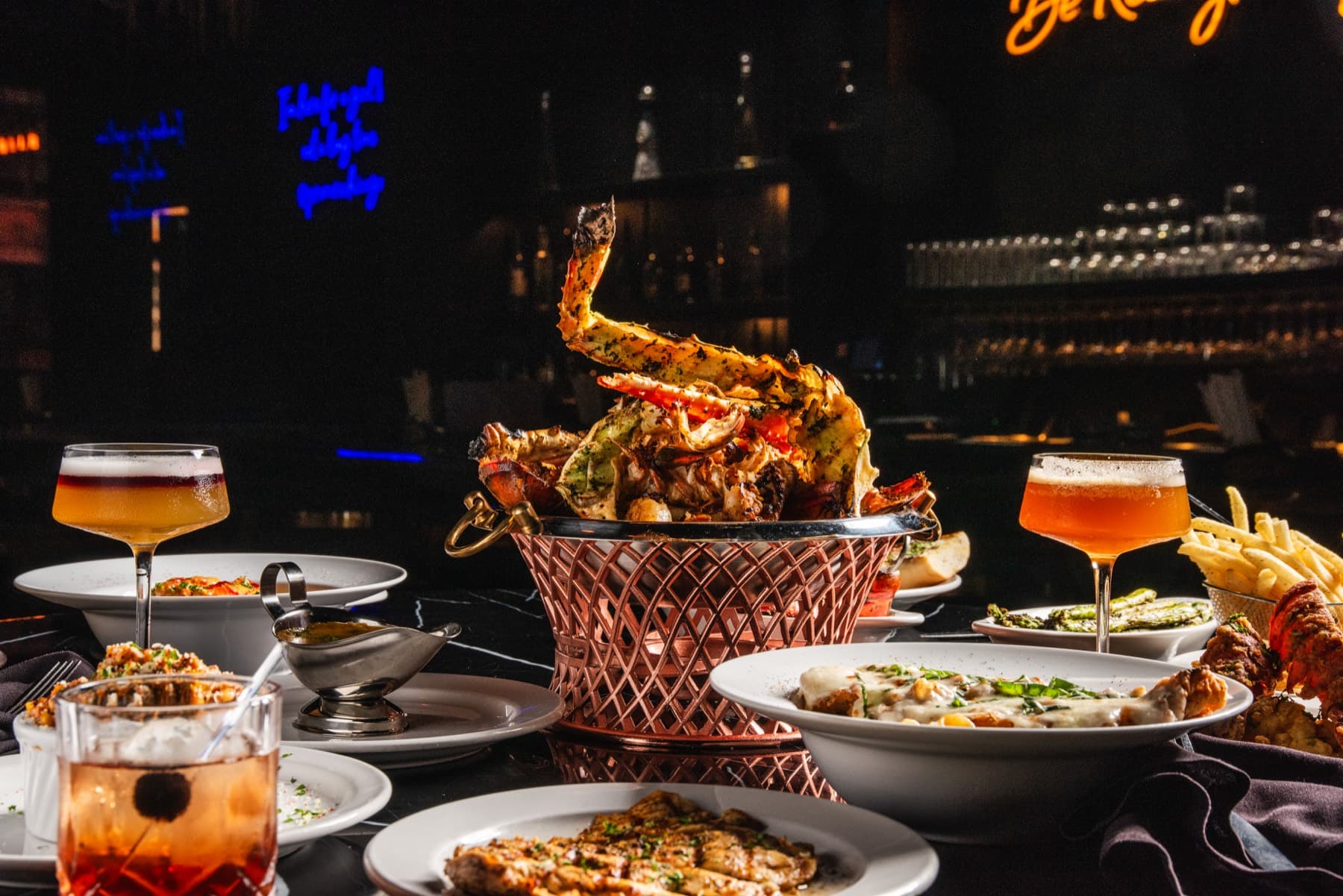 The Provaré seafood tower surrounded by dinner plates and cocktails